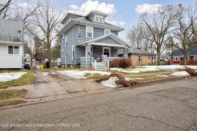 traditional style home with driveway and a porch