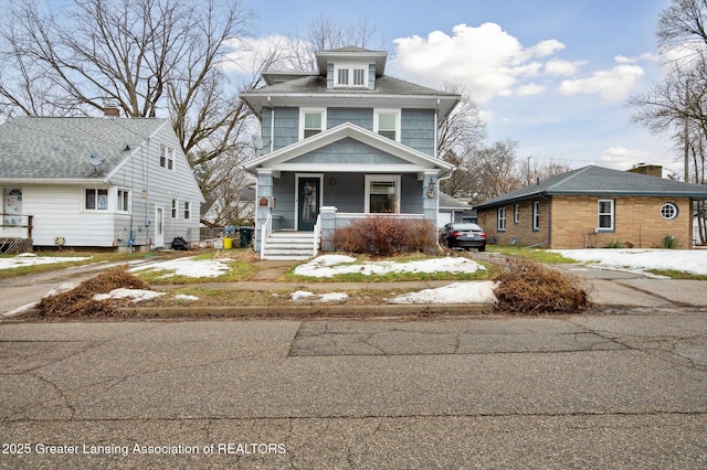 traditional style home with a porch and driveway