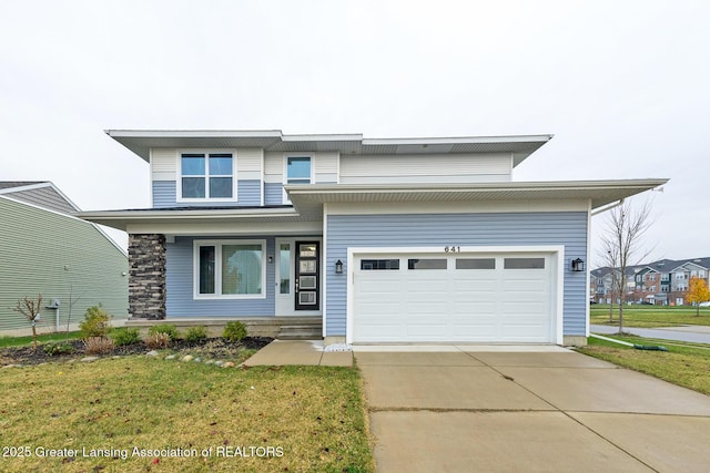 view of front of property featuring a garage, concrete driveway, covered porch, and a front lawn