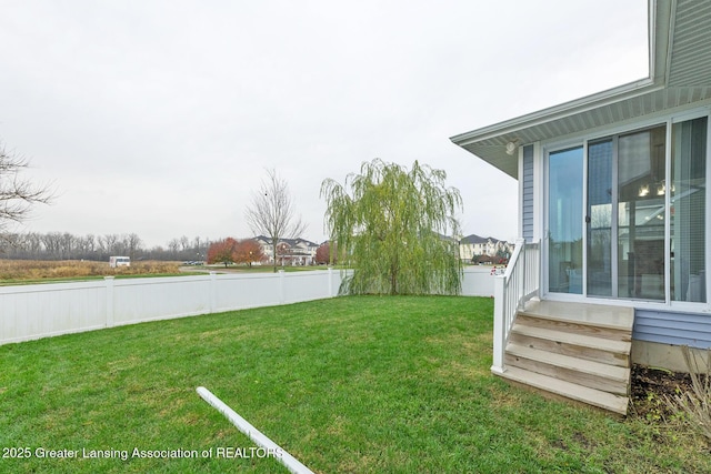 view of yard with entry steps and fence