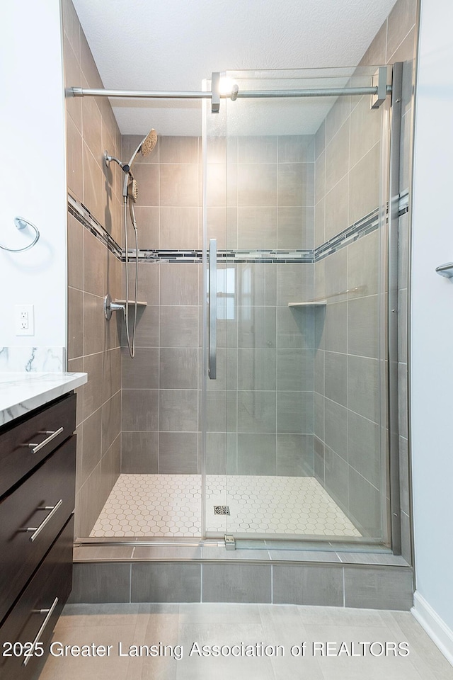 full bath featuring a stall shower and vanity