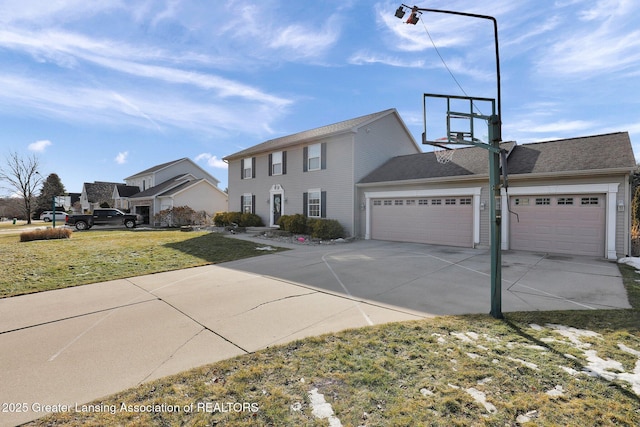 view of front of home with a garage, concrete driveway, and a front lawn