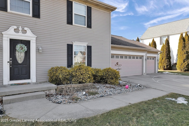 exterior space featuring concrete driveway and an attached garage