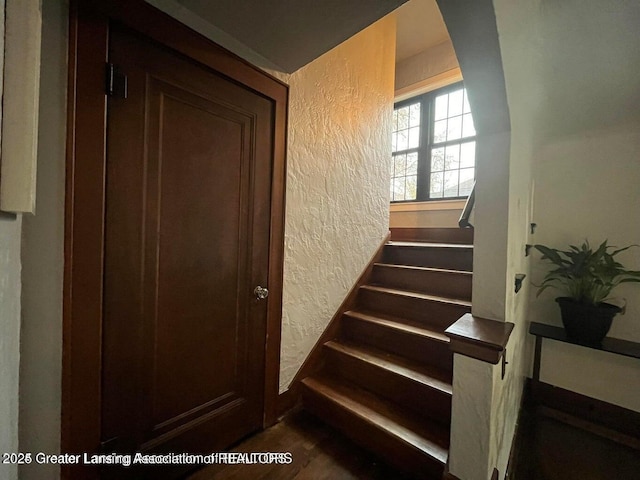 staircase with a textured wall