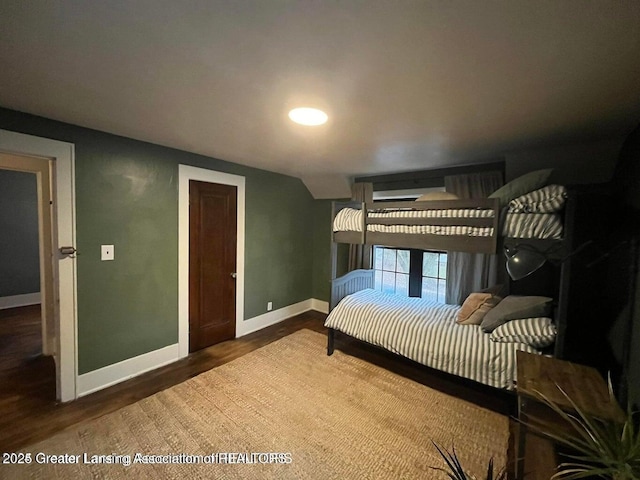 bedroom featuring baseboards and wood finished floors