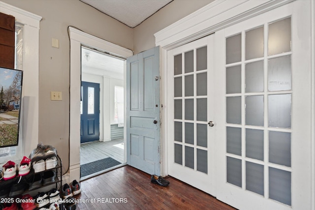 entrance foyer featuring dark wood-style floors and french doors