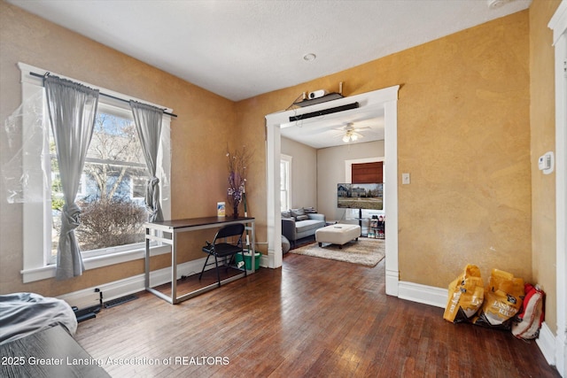 interior space featuring a wealth of natural light, baseboards, ceiling fan, and hardwood / wood-style floors