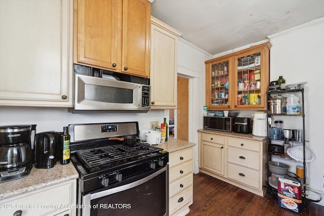 kitchen featuring dark wood-style floors, glass insert cabinets, light stone countertops, stainless steel appliances, and crown molding