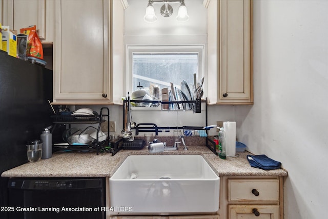 kitchen with cream cabinetry, a sink, and black appliances