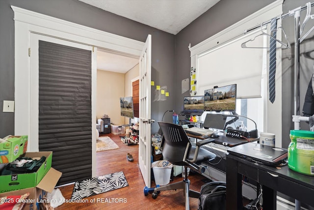 office space with a textured ceiling and wood finished floors