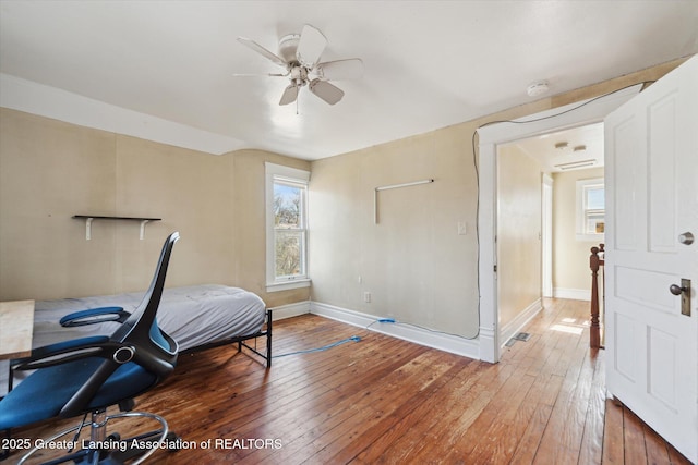 office area featuring wood-type flooring, visible vents, and baseboards