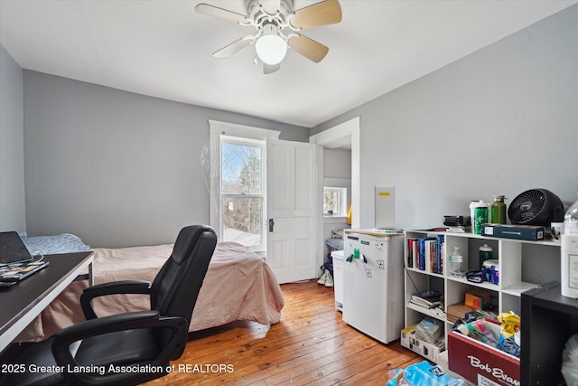 bedroom with hardwood / wood-style flooring and a ceiling fan