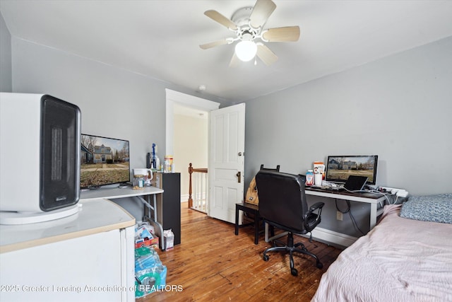 bedroom featuring baseboards, ceiling fan, and light wood finished floors