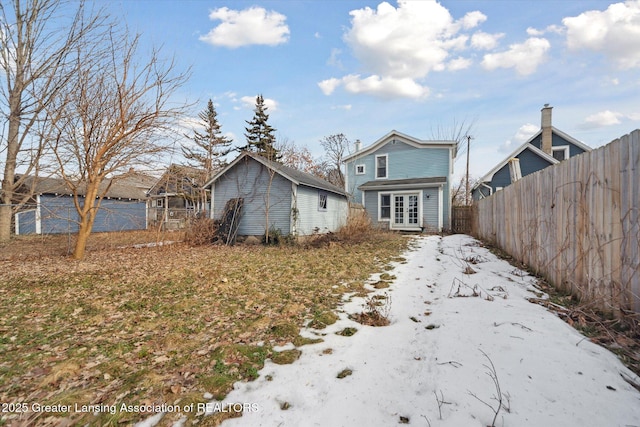 rear view of house featuring french doors and fence