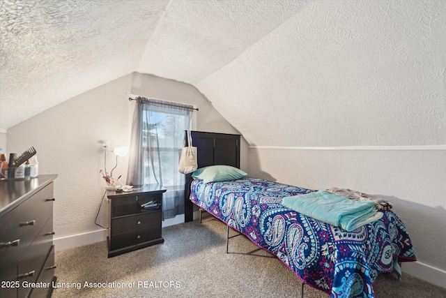 bedroom featuring baseboards, a textured wall, lofted ceiling, carpet flooring, and a textured ceiling