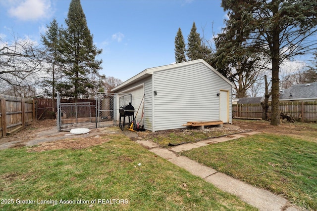 exterior space featuring a gate, a fenced backyard, an outdoor structure, and a lawn