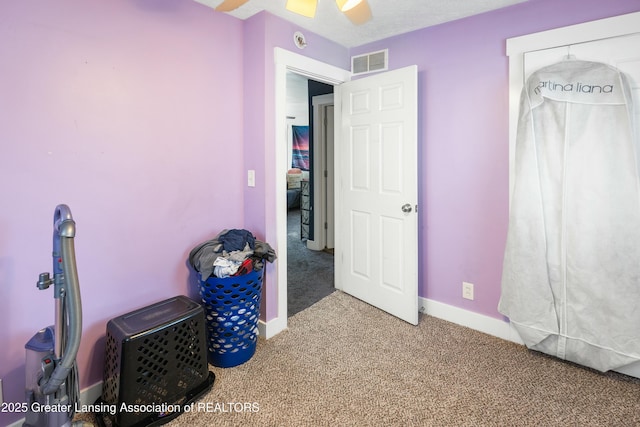 carpeted bedroom featuring visible vents and baseboards