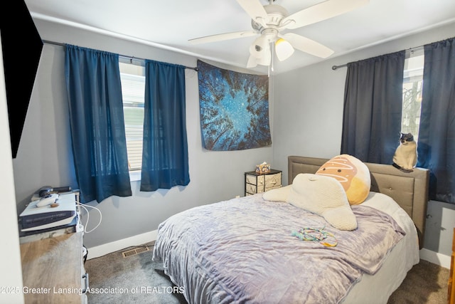 bedroom with carpet floors, visible vents, and baseboards