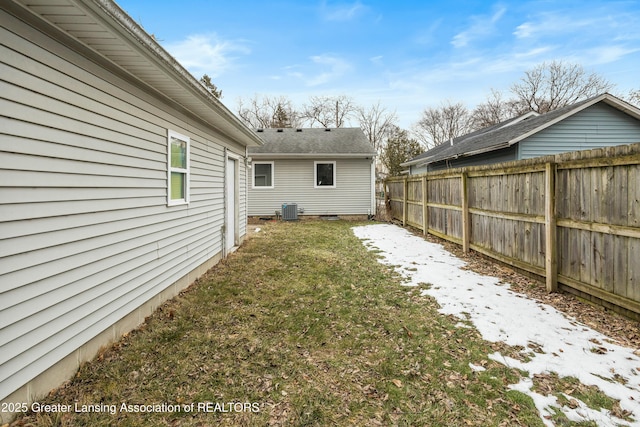 view of yard with fence and central AC unit