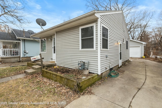 exterior space with an outdoor structure and a detached garage