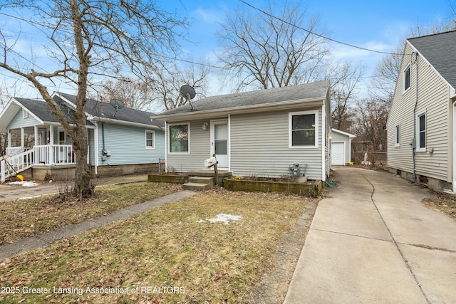 view of front of home with a porch, an outbuilding, and a garage