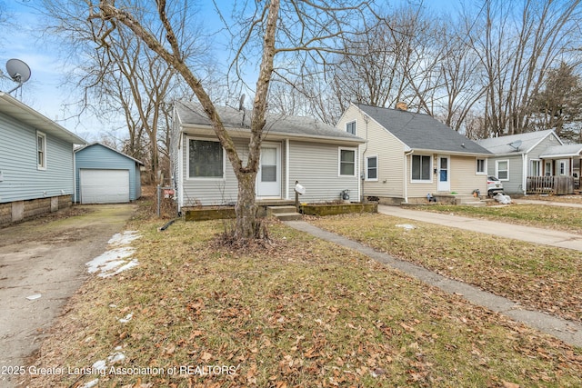 view of front of home with an outbuilding, concrete driveway, and a detached garage