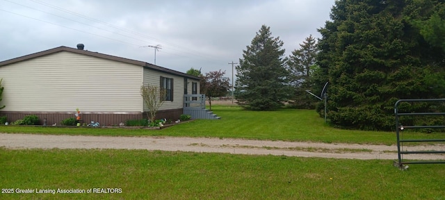 11173 W Bennett Rd, Sumner, MI 48889 - view of side of home featuring a yard