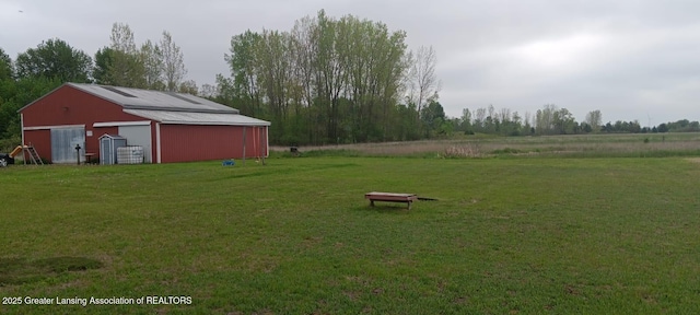 11173 W Bennett Rd, Sumner, MI 48889 - view of grassy yard featuring an outbuilding and a detached garage