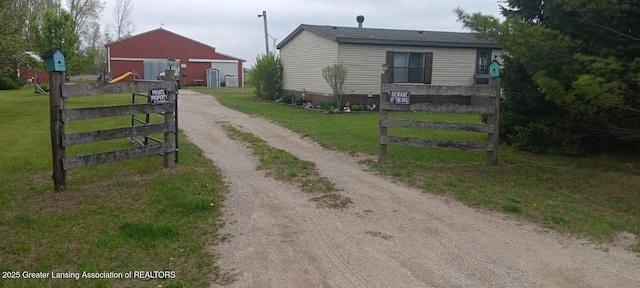 11173 W Bennett Rd, Sumner, MI 48889 - view of front of house featuring dirt driveway and an outdoor structure