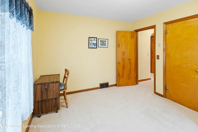 office with carpet floors, visible vents, and baseboards