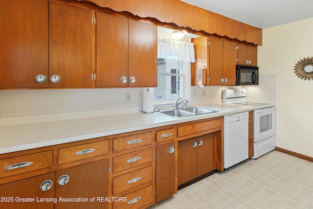 kitchen with white dishwasher, light countertops, black microwave, a sink, and range with electric stovetop