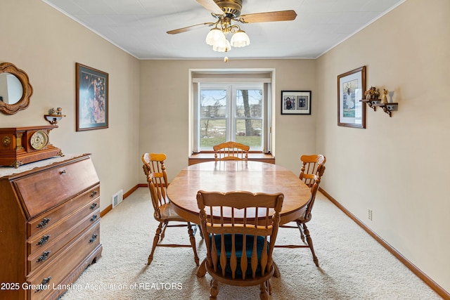 dining area featuring carpet floors, visible vents, and baseboards