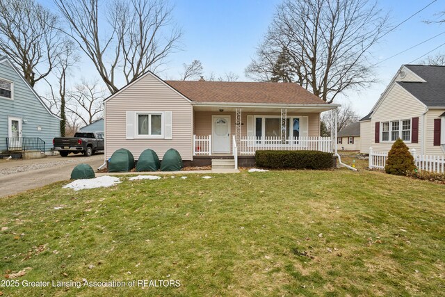 bungalow-style house with aphalt driveway, a front lawn, and a porch