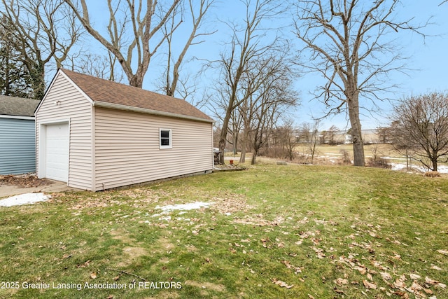 view of yard featuring an outbuilding and a detached garage