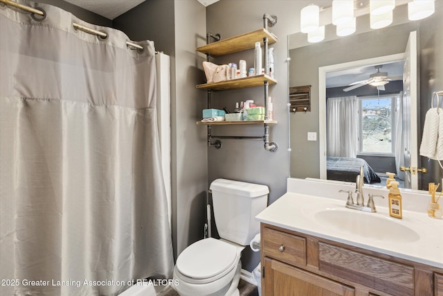 bathroom with toilet, vanity, a ceiling fan, and ensuite bathroom