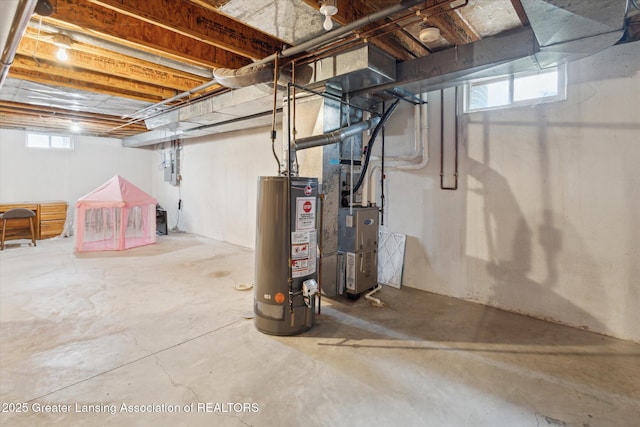 basement featuring a healthy amount of sunlight and gas water heater