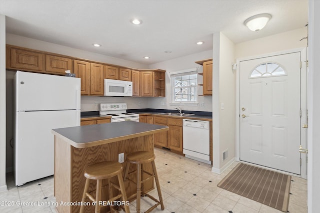 kitchen featuring white appliances, visible vents, a center island, open shelves, and dark countertops