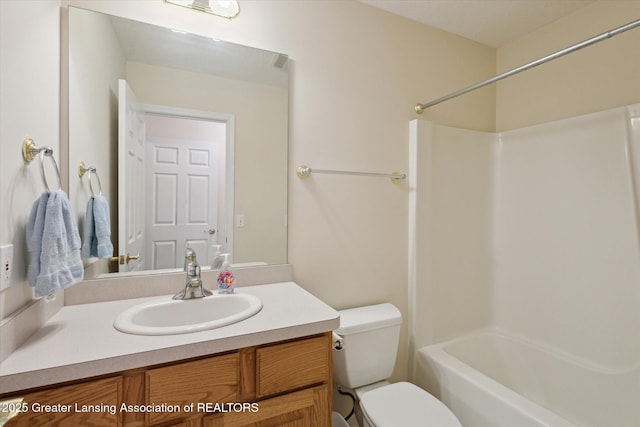 bathroom featuring toilet, shower / washtub combination, and vanity