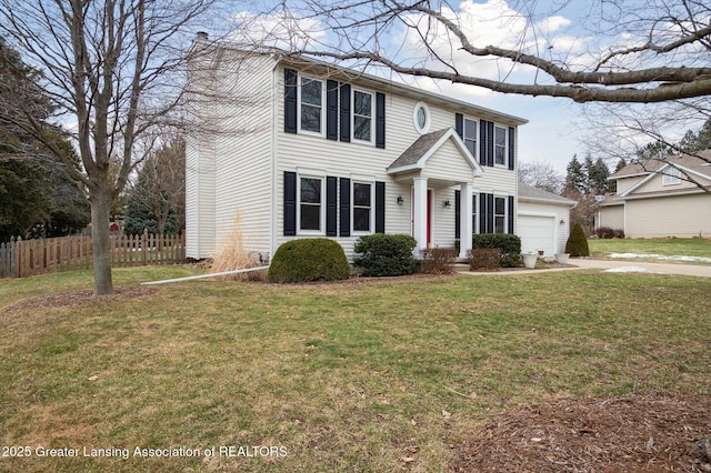 colonial house with a garage, fence, concrete driveway, a front lawn, and a chimney