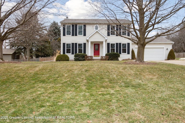 colonial inspired home featuring a garage, concrete driveway, a front lawn, and fence