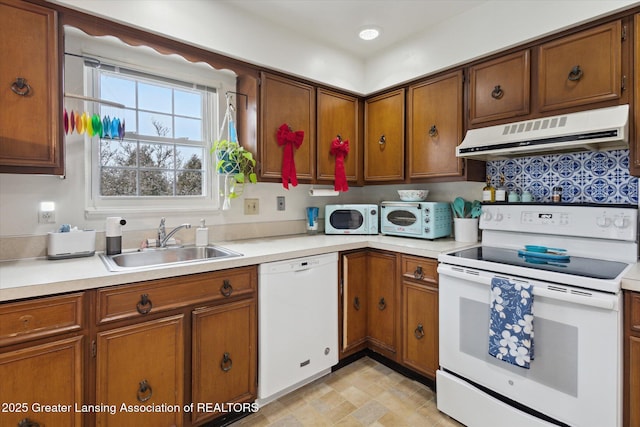 kitchen featuring white appliances, brown cabinets, a sink, and extractor fan