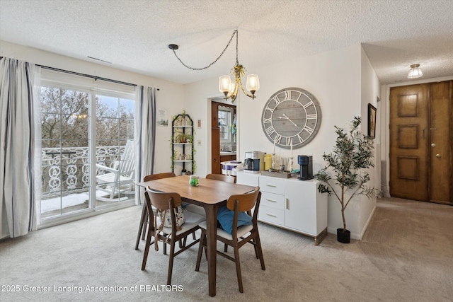 dining space with light carpet, a textured ceiling, baseboards, and an inviting chandelier