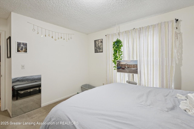 carpeted bedroom featuring a textured ceiling