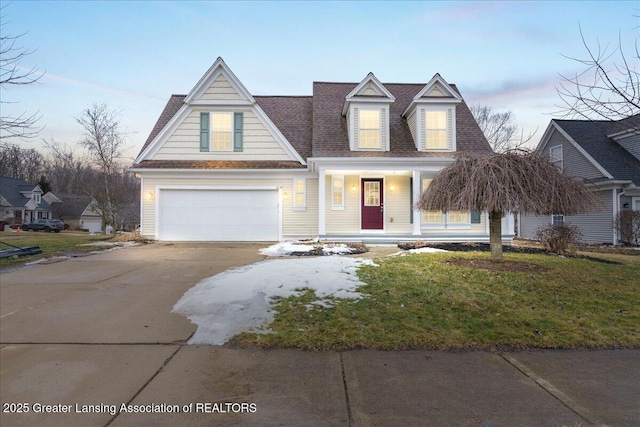 view of front of home featuring a garage, concrete driveway, roof with shingles, a front lawn, and a porch