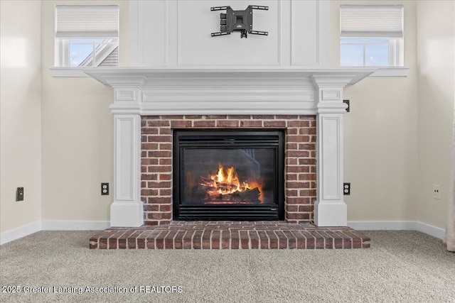 details with a brick fireplace, carpet flooring, and baseboards