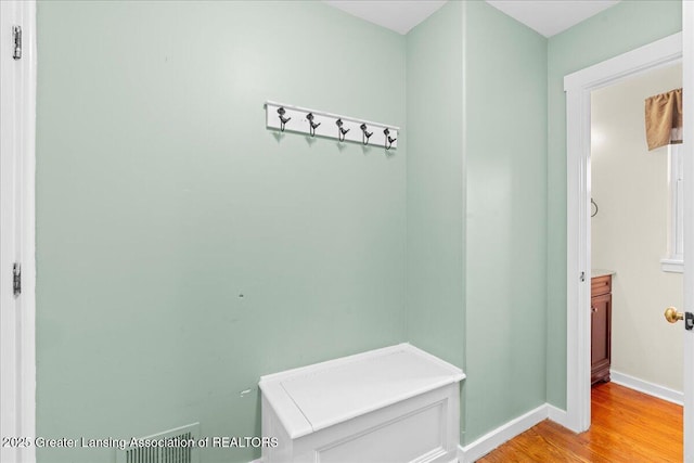 mudroom with baseboards and light wood-style floors