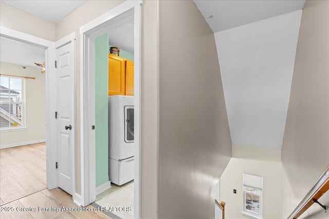 interior space with washer / dryer, light wood-type flooring, and baseboards