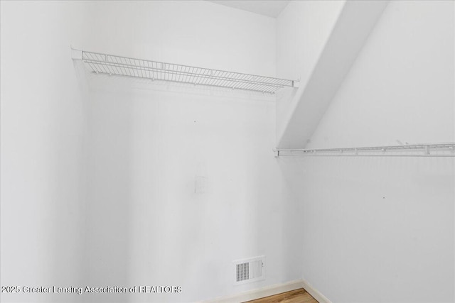 walk in closet with visible vents and light wood finished floors