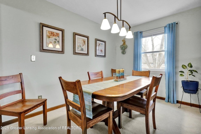 dining space featuring carpet and baseboards