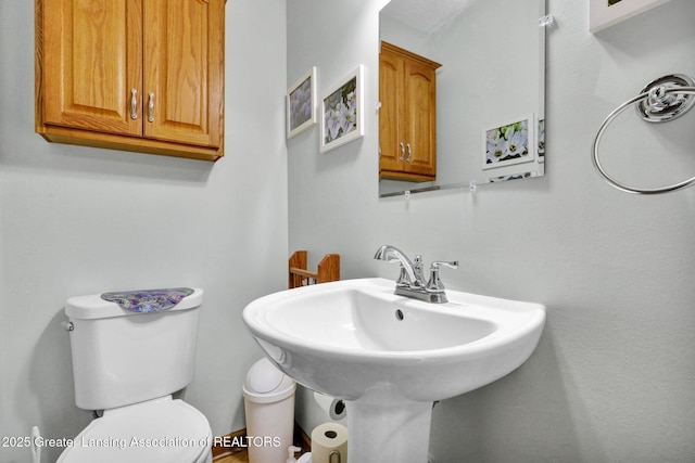 half bath featuring a sink and toilet